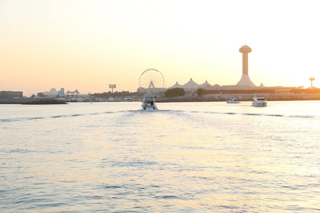 Photo for Abu Dhabi Cornish with book boat and yacht cruising during sunset